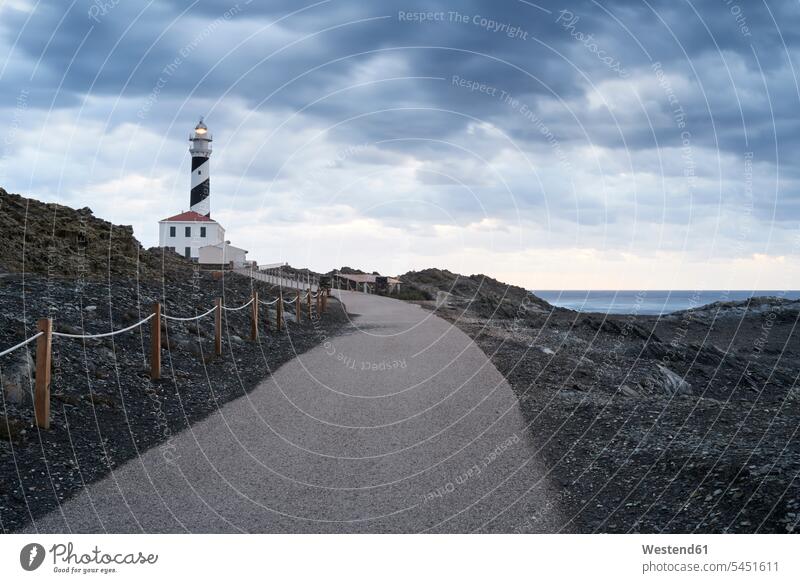 Spain, Balearic Islands, Menorca, Favaritx lighthouse surrounded by clouds in the morning coast coastline coast area Seacoast seaside Orientation morning light