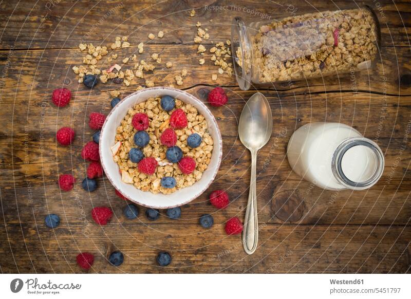 Bowl of granola with raspberries and blueberries arrangement grouping Oat Flakes rolled oats abundance Plentiful Fruit Fruits healthy eating nutrition Breakfast