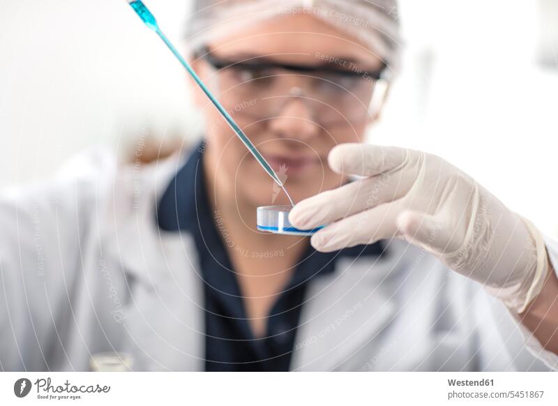 Scientist working in lab with pipet and petri dish laboratory test testing petri dishes female scientists At Work science sciences scientific pipette dropper