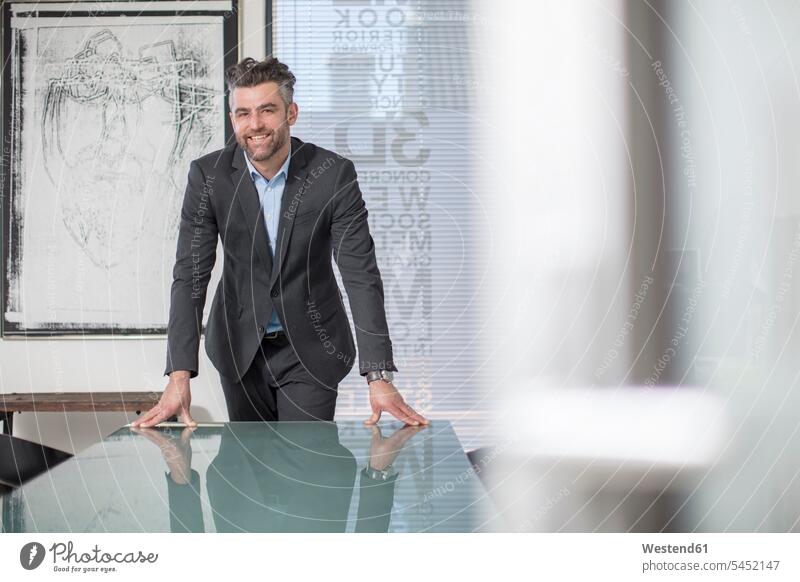 Portrait of confident businessman in office smiling smile offices office room office rooms Businessman Business man Businessmen Business men portrait portraits