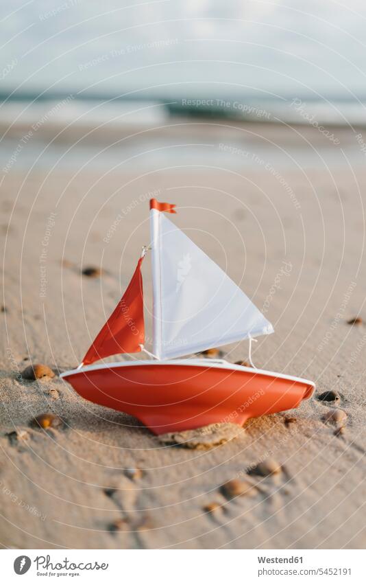 Toy boat an the beach beaches boats vacation Holidays Travel close-up close up closeups close ups close-ups toy toys model boat outdoors outdoor shots