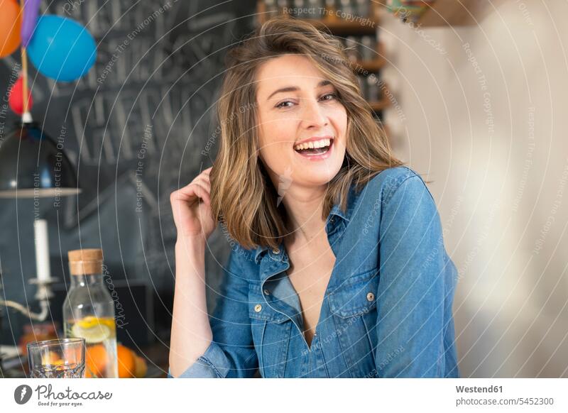 Portrait of laughing woman in the kitchen portrait portraits females women Adults grown-ups grownups adult people persons human being humans human beings