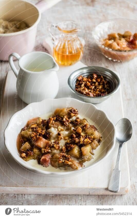 Bowl of porridge with rhubarb compote, honey and nuts focus on foreground Focus In The Foreground focus on the foreground Rhubarb Compote close-up close up