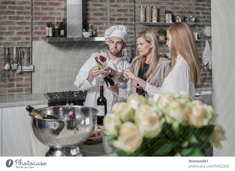 Chef with two women in kitchen tasting wine chef cook cooks Chefs Red Wine Red Wines cooking course cooking class cooking lesson Alcohol alcoholic beverage