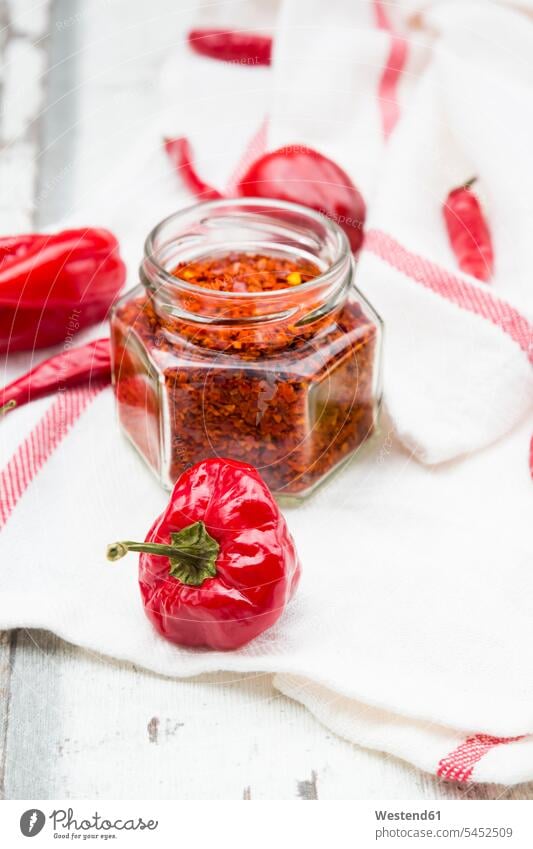 Glass of chili flakes and red chili pods on kitchen towel food and drink Nutrition Alimentation Food and Drinks hot spicy sort sorts various different variation