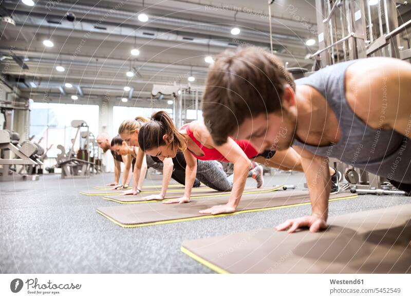 Woman Push-ups On The Floor At The Gym Stock Photo, Picture and