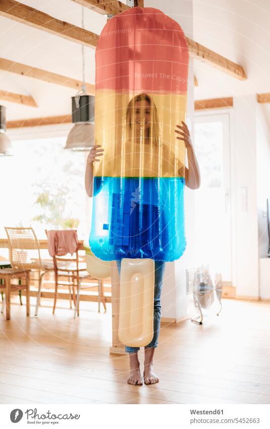 Young woman standing barefoot in her flat with an ice lolly shaped airbed home at home cooling Cool Down cooling down Ice Lolly Iced Lolly Ice Lollies