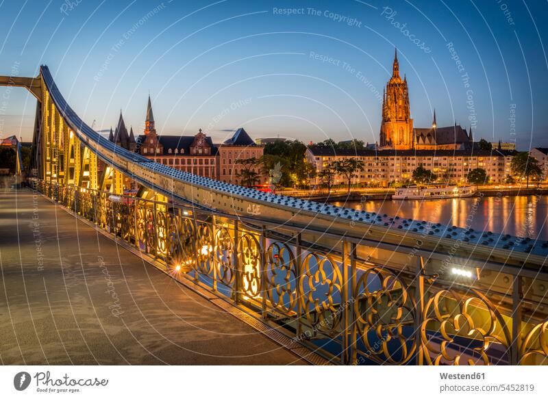 Germany, Frankfurt, view from Eiserner Steg to lighted Frankfurt Cathedral evening in the evening Railing Railings Incidental people People In The Background