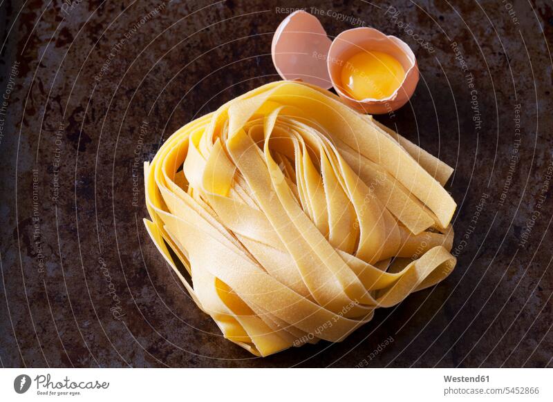 Raw Pappardelle pasta and egg uncooked close-up close up closeups close ups close-ups Egg Eggs Ribbon Noodles broad noddles Ribbon Pasta raw copy space