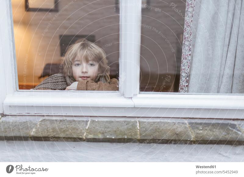 Portrait of pensive boy looking out of window thoughtful Reflective contemplative watching portrait portraits windows boys males view seeing viewing child