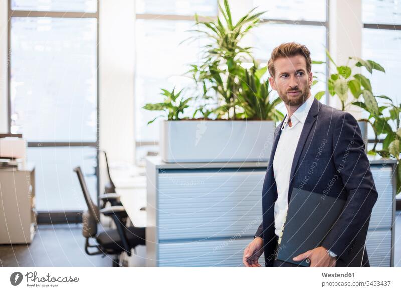 Portrait of businessman with folder portrait portraits office offices office room office rooms Businessman Business man Businessmen Business men workplace