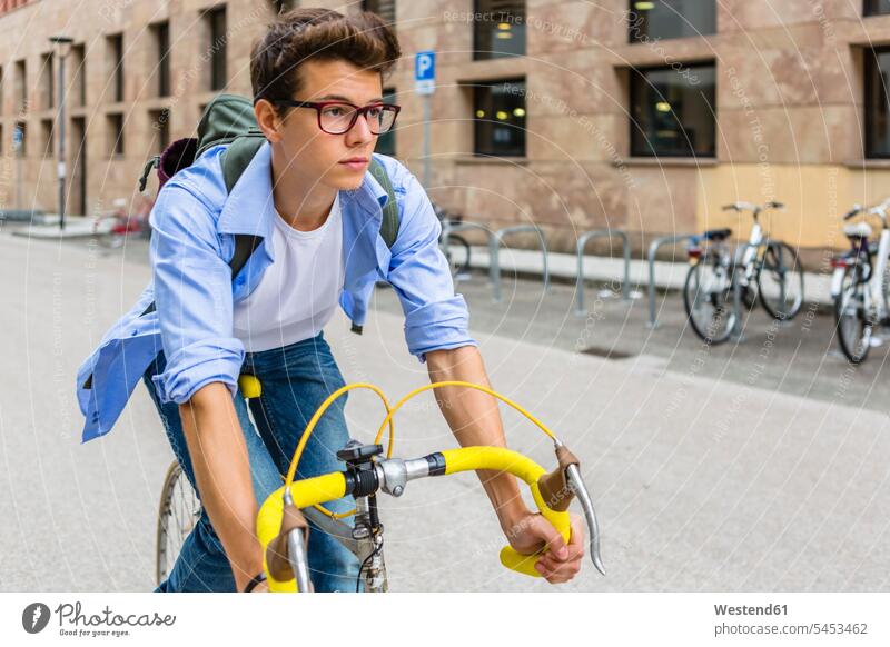 Portrait of young man riding on racing cycle men males cyclist portrait portraits Adults grown-ups grownups adult people persons human being humans human beings