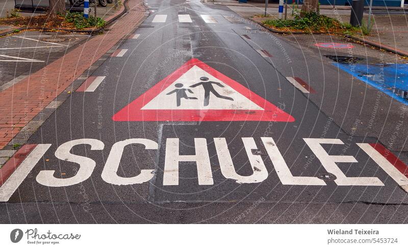 Warning sign for playing children painted on the asphalt. This sign was near to a school children at play street sign watch for children children playing run