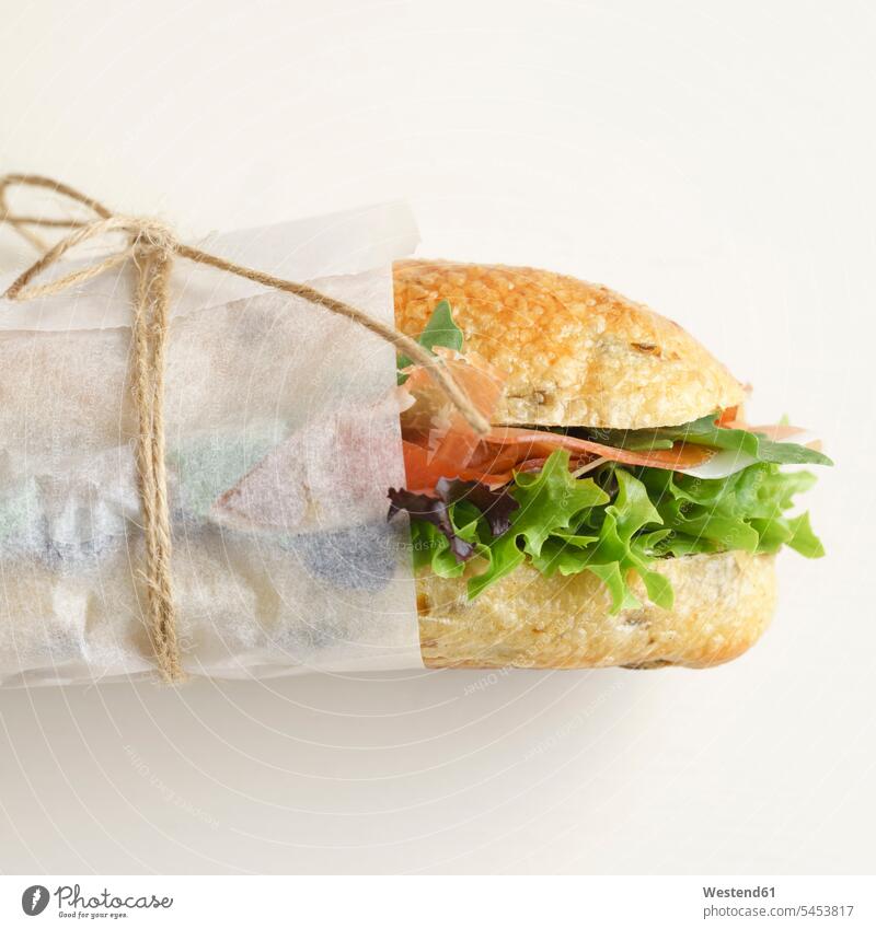 Olive baguette with lettuce and ham food and drink Nutrition Alimentation Food and Drinks olive baguette lettuce leaf lettuce leaves wrapped Wrapped Up nobody