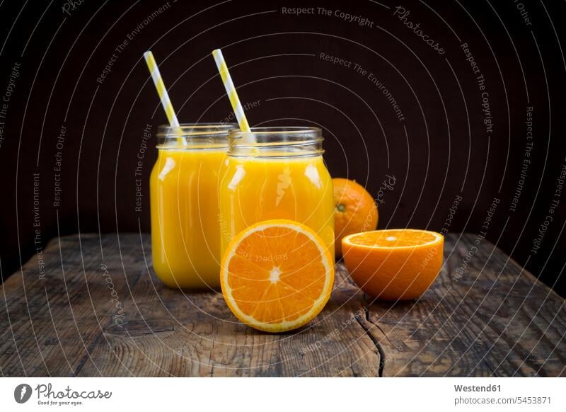 Freshly squeezed orange juice in jars with straws food and drink Nutrition Alimentation Food and Drinks sliced drinking straw drinking straws half halves halved