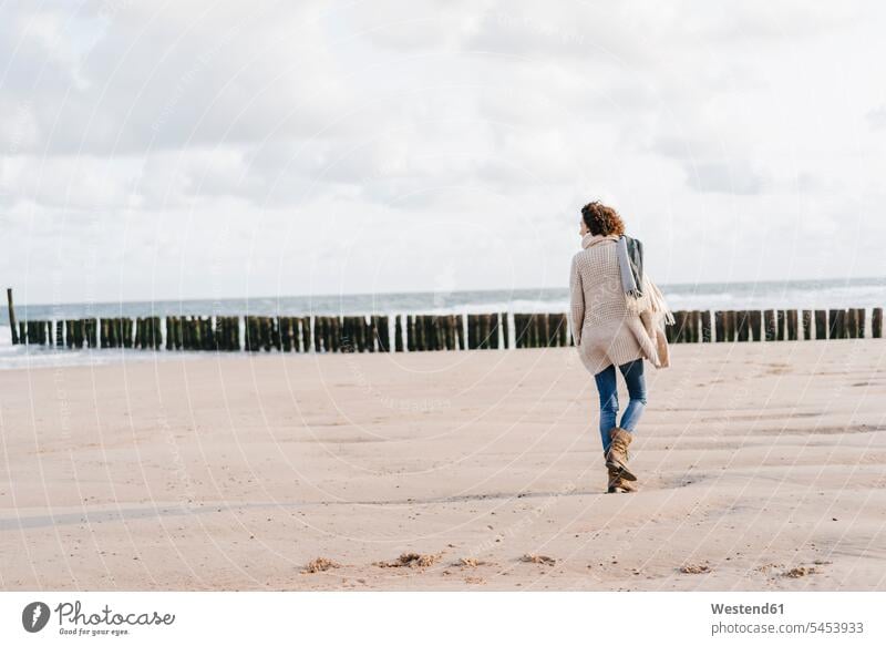 Woman walking on the beach going woman females women beaches Adults grown-ups grownups adult people persons human being humans human beings vacation Holidays