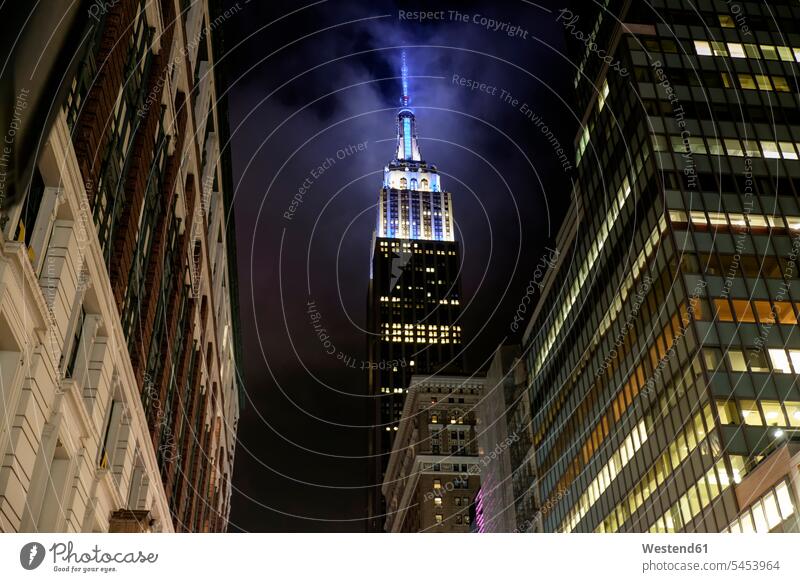 USA, New York, High-rise buildings and Empire State Building at night illuminated lit lighted Illuminating skyscraper skyscrapers multistory building high rise