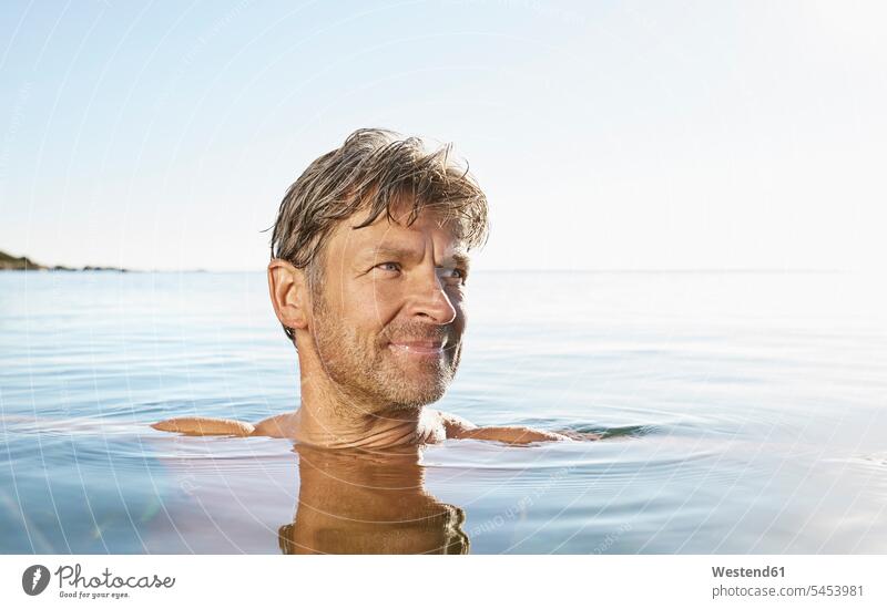 Portrait of smiling man bathing in the sea Sea ocean men males portrait portraits bathe Taking A Bath water Adults grown-ups grownups adult people persons