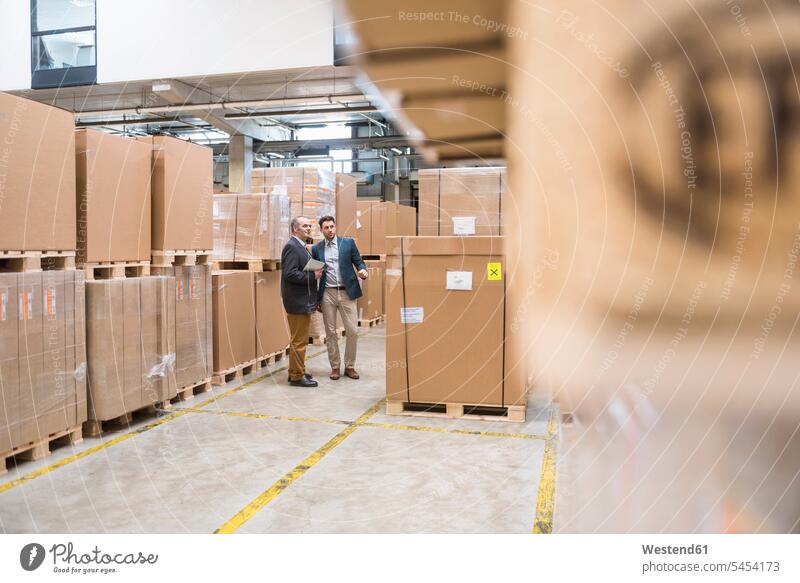 Two men standing in factory warehouse tablet digitizer Tablet Computer Tablet PC Tablet Computers iPad Digital Tablet digital tablets man males colleagues