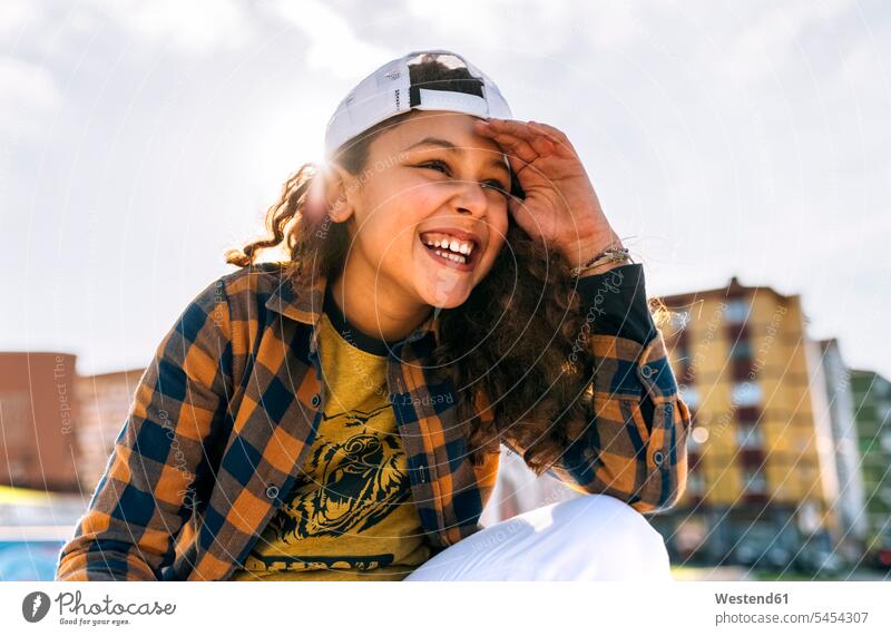 Portrait of laughing girl wearing baseball cap Laughter females girls portrait portraits positive Emotion Feeling Feelings Sentiments Emotions emotional child