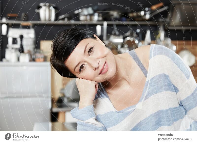 Portrait of smiling woman in kitchen smile portrait portraits females women Adults grown-ups grownups adult people persons human being humans human beings