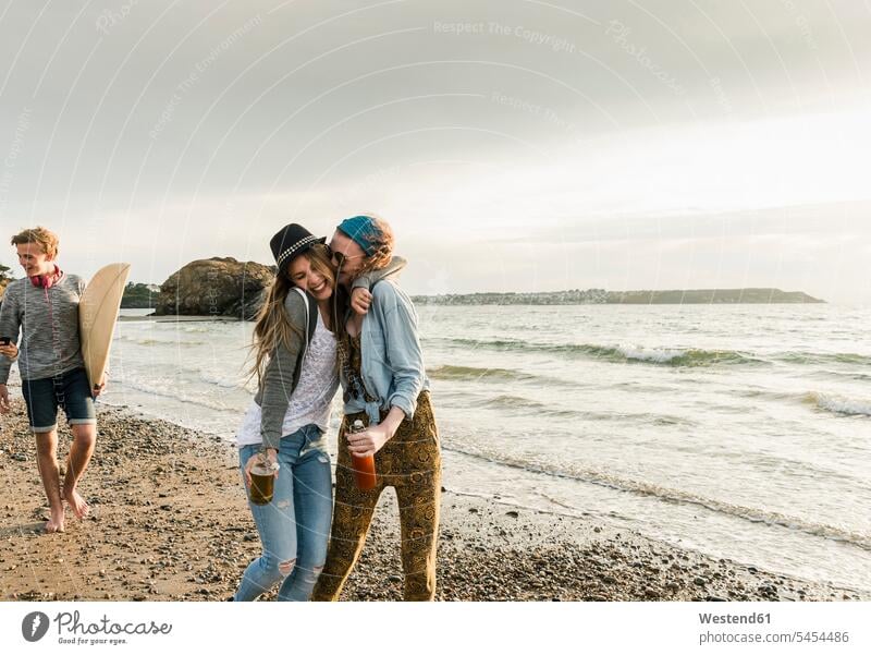 Happy friends with drinks hugging on the beach happiness happy beaches female friends embracing embrace Embracement mate friendship vacation Holidays Travel