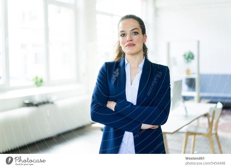 Portrait of confident businesswoman in a loft portrait portraits standing businesswomen business woman business women females business people businesspeople