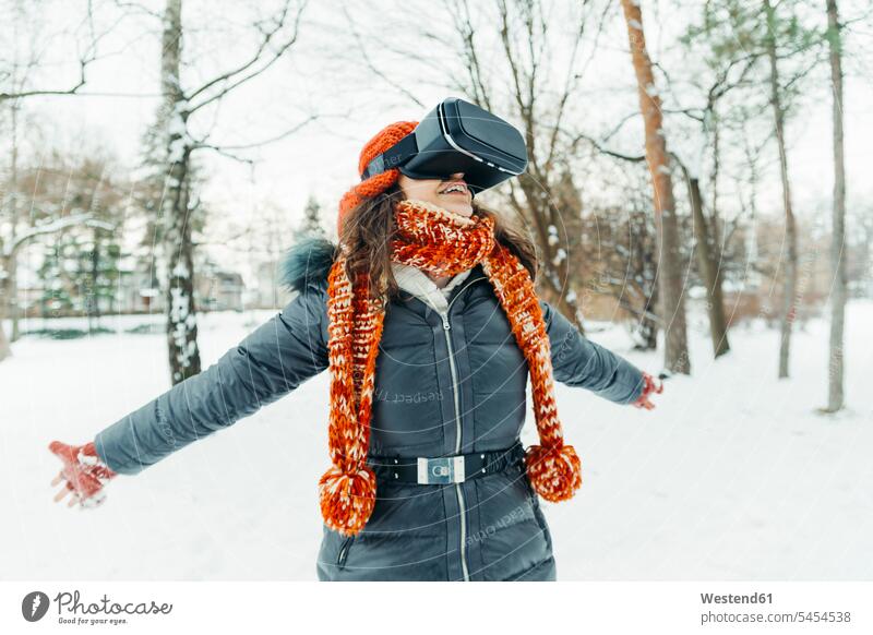 Woman wearing Virtual Reality Glasses in winter landscape woman females women VR glasses Virtual-Reality Glasses virtual reality headset vr headset vr goggles