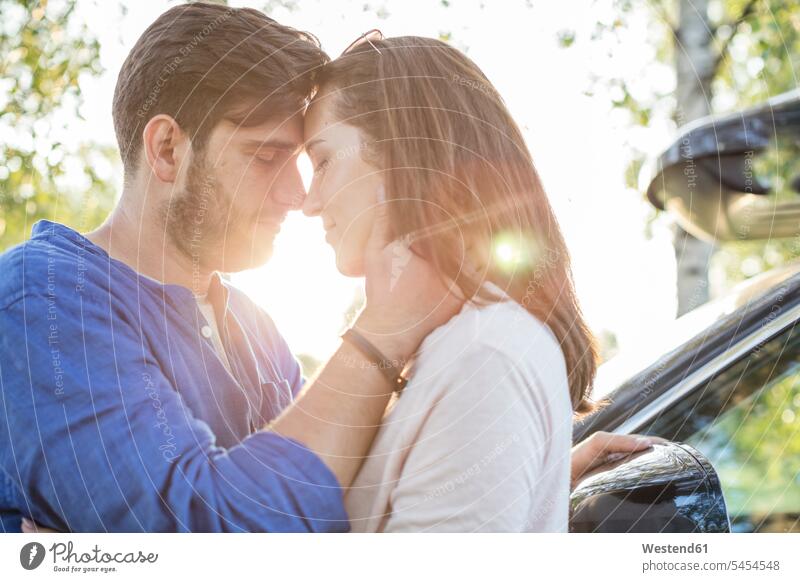 Couple embracing and kissing while on a road trip romantic lyrical Romance kisses Love loving couple twosomes partnership couples embrace Embracement hug