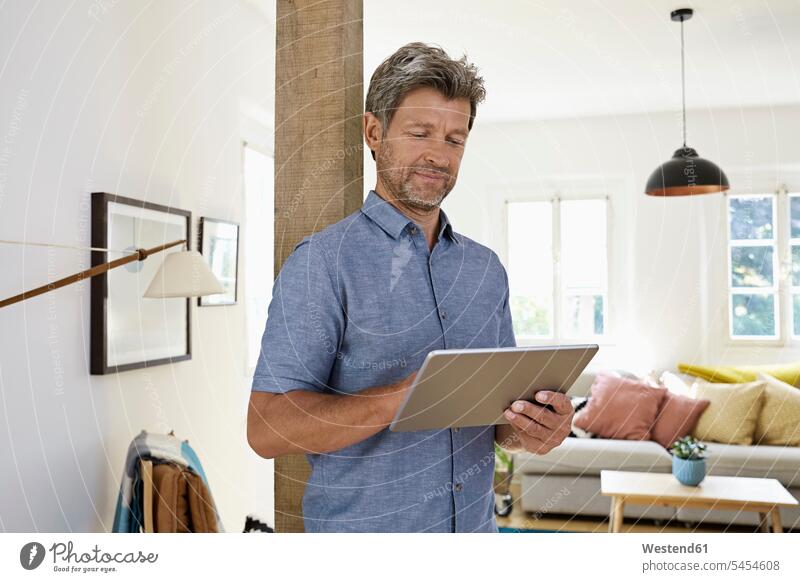 Mature man at home using digital tablet Internet The Internet digitizer Tablet Computer Tablet PC Tablet Computers iPad Digital Tablet digital tablets Control