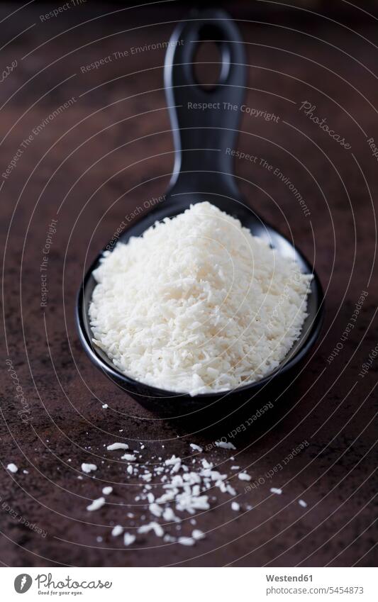 Spoon of coconut flakes white grated Cocos dark background scattered copy space focus on foreground Focus In The Foreground focus on the foreground metal metals