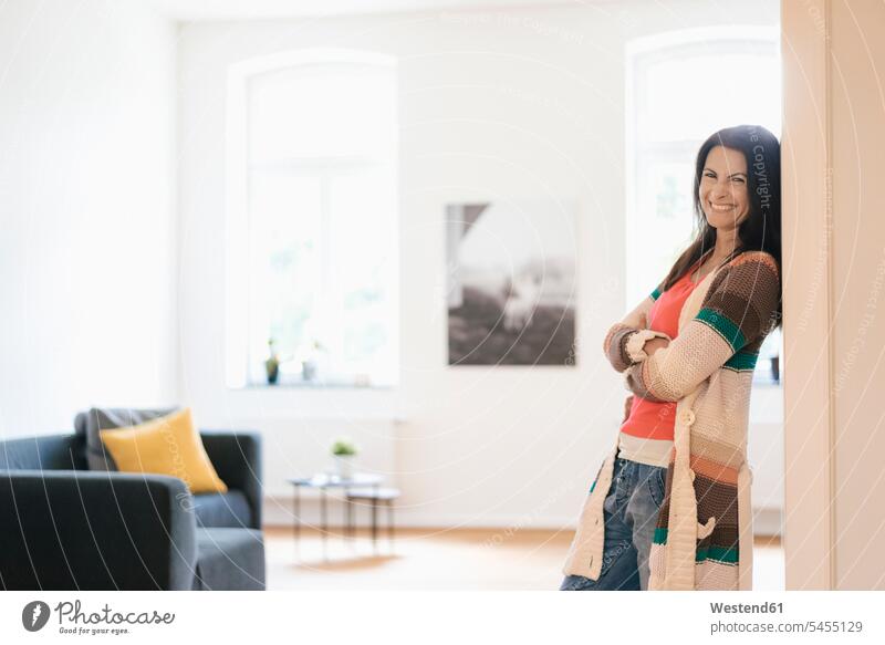 Portrait of happy woman at home smiling smile standing females women Adults grown-ups grownups adult people persons human being humans human beings arms crossed