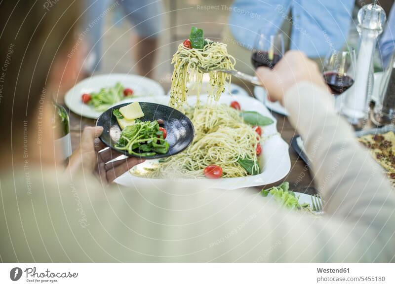 Eating spaghetti for lunch in garden Spaghetti group of people Group groups of people celebrating celebrate partying Red Wine Red Wines eating Pasta Noodle