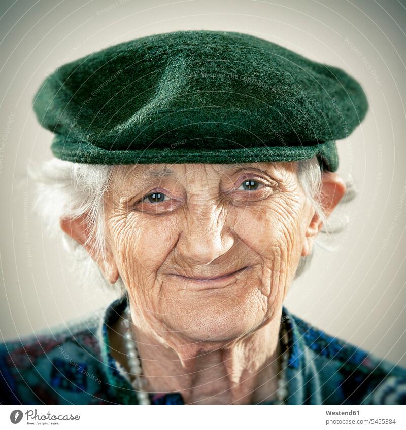 Portrait of an elderly lady wearing a cap Candid smiling smile portrait portraits old senior women elder women elder woman senior woman senior adults females