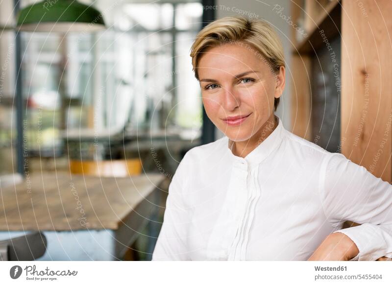 Portrait of confident blond woman portrait portraits businesswoman businesswomen business woman business women smiling smile females business people