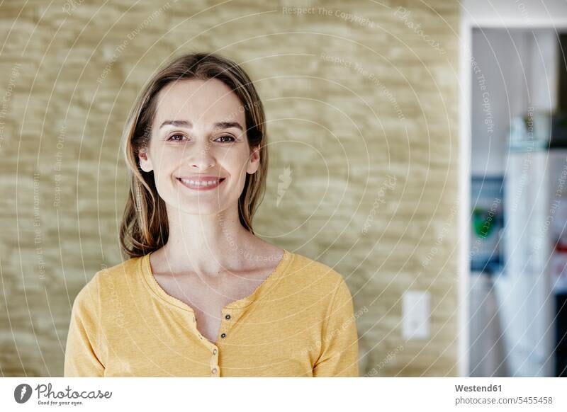 Portrait of smiling woman at home smile portrait portraits females women Adults grown-ups grownups adult people persons human being humans human beings Joy