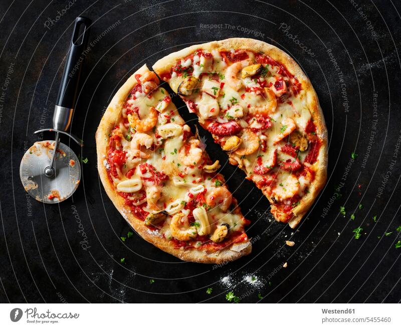 Sliced pizza with frutti di mare on dark ground food and drink Nutrition Alimentation Food and Drinks prepared ready to eat ready-to-eat garnished seafood