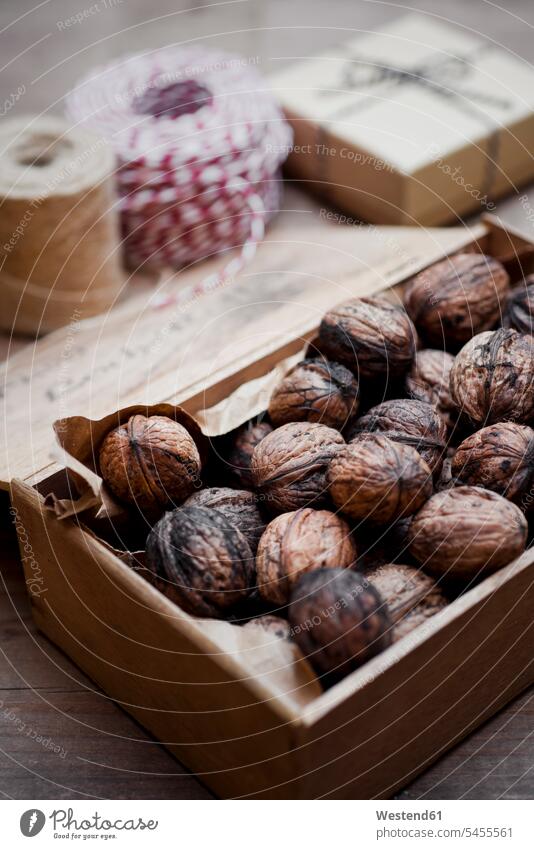 Wooden box of organic walnuts food and drink Nutrition Alimentation Food and Drinks Brown Paper brown string strings packing paper wooden box wooden boxes