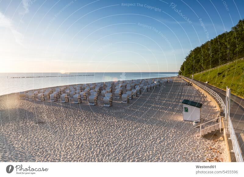 Germany, Ruegen, Sellin, view to beach with hooded beach chairs at morning twilight roofed wicker beach chair Hooded Beach Chairs morning light