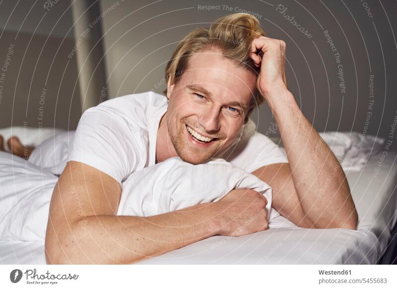 Portrait of smiling young woman standing wearing bra and pyjama pants stock  photo