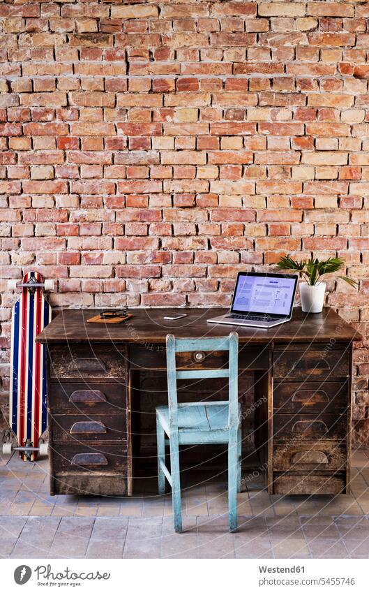 Vintage workspace at brick wall in office desk desks skateboard Skate Board skateboards laptop Laptop Computers laptops notebook offices office room