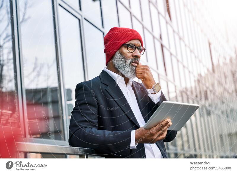 Mature businessman using digital tablet in the street thinking digitizer Tablet Computer Tablet PC Tablet Computers iPad Digital Tablet digital tablets