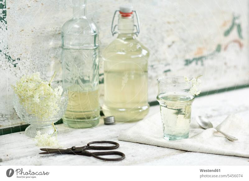 Glass bottles of elderflower sirup and elderflowers food and drink Nutrition Alimentation Food and Drinks liquid fluid still life still-lifes still lifes sweet