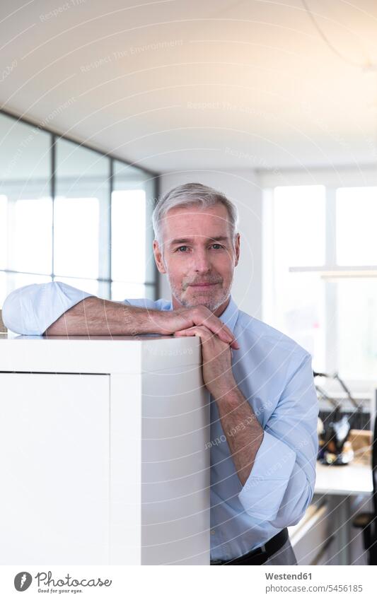 Successful businessman in his office, looking confident planning office leaning rested on Planning planned modern contemporary expertise competence competent