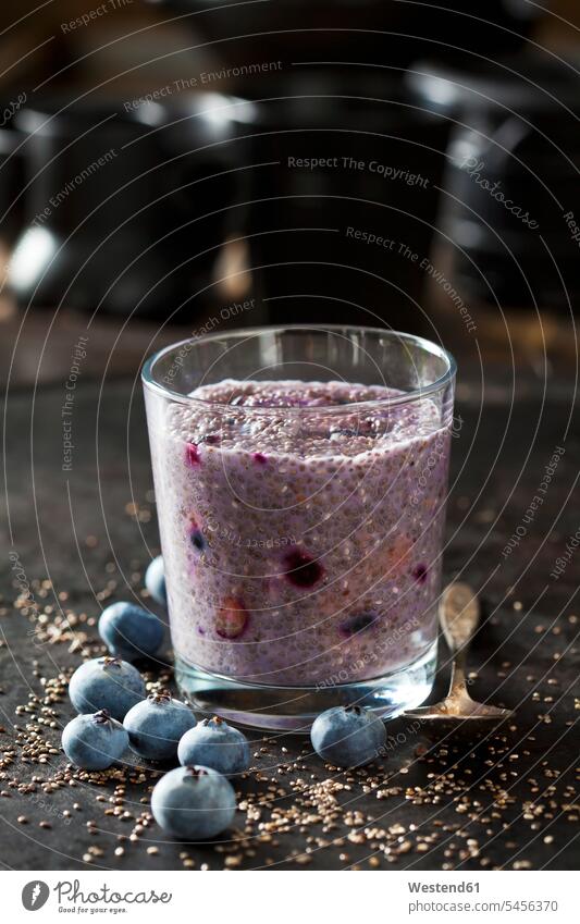 Dessert of chia seeds, cacao nibs and blueberries Glass Drinking Glasses tea spoon Teaspoon tea spoons Afters Desserts scattered dark background silver spoon