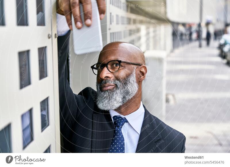 Mature businessman taking selfie in the street Businessman Business man Businessmen Business men photographing Selfie Selfies on the move on the way on the go