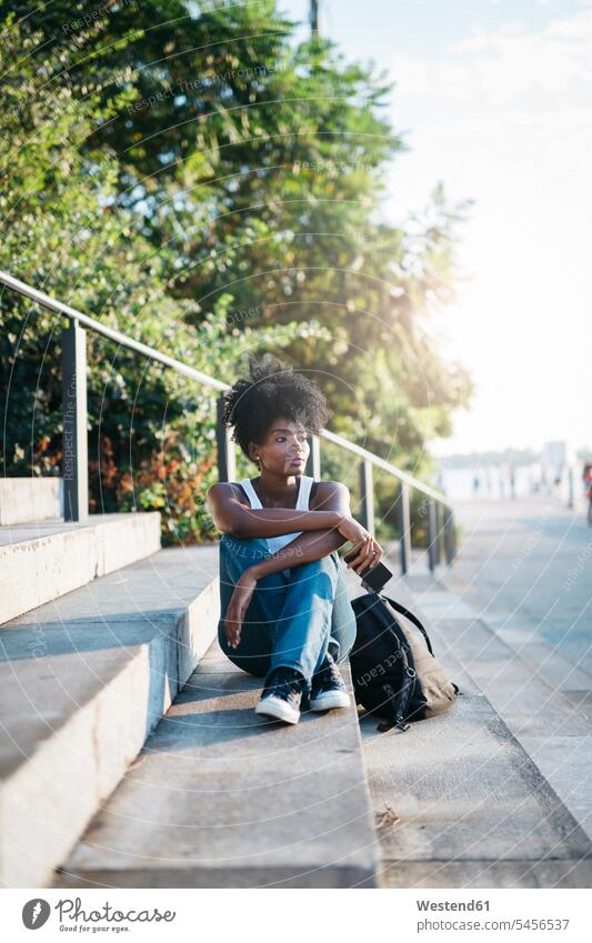 Woman sitting on stairs outdoors Seated mobile phone mobiles mobile phones Cellphone cell phone cell phones stairway woman females women portrait portraits