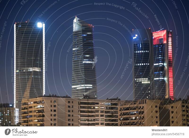 Spain, Madrid, lighted skyscrapers at financial district by night illuminated lit Illuminating bank building modern architecture Contemporary Architecture