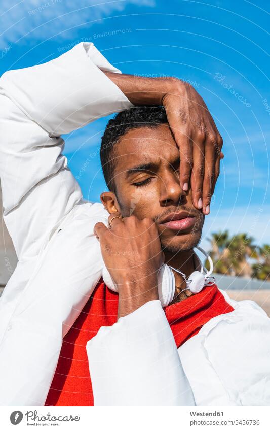 Portait of young man outdoors with hands on face human human being human beings humans person persons adult grown-up grown-ups grownup grownups young adult