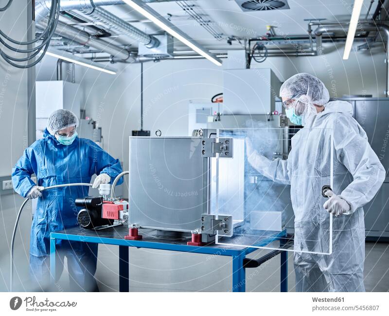 Chemists working in industrial laboratory clean room At Work Protective Suit chemist Chemical Laboratory sterile clothing hygiene natural scientist science